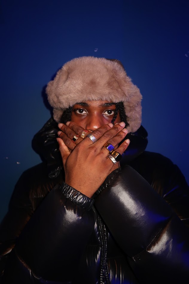 Editorial portrait against a deep blue background