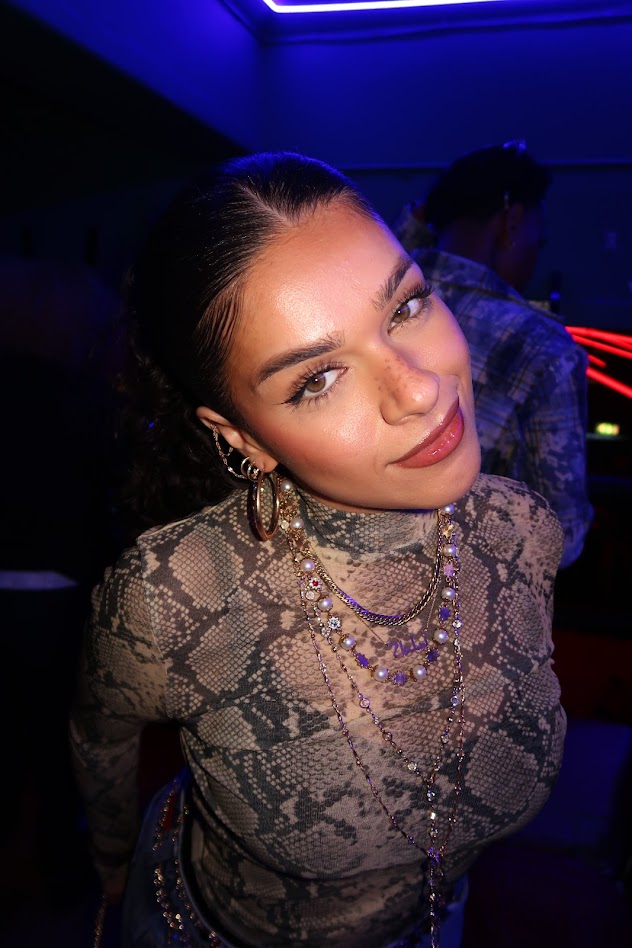 Close-up nightlife portrait under blue lights